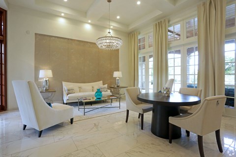 a living room with a table and chairs and a couch